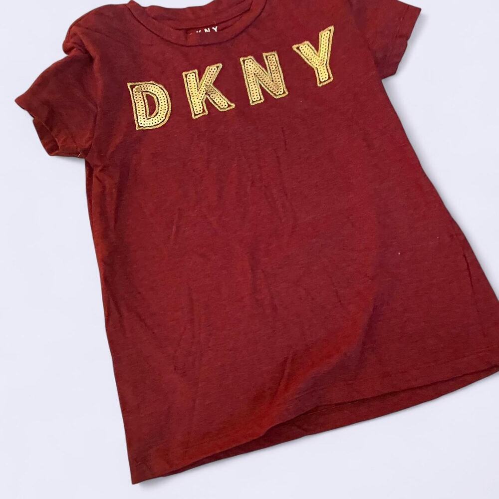 Girls Burgundy DKNY short sleeve shirt with crisscross on shoulders